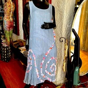 Blue linen tank dress with scrolled touching detail.